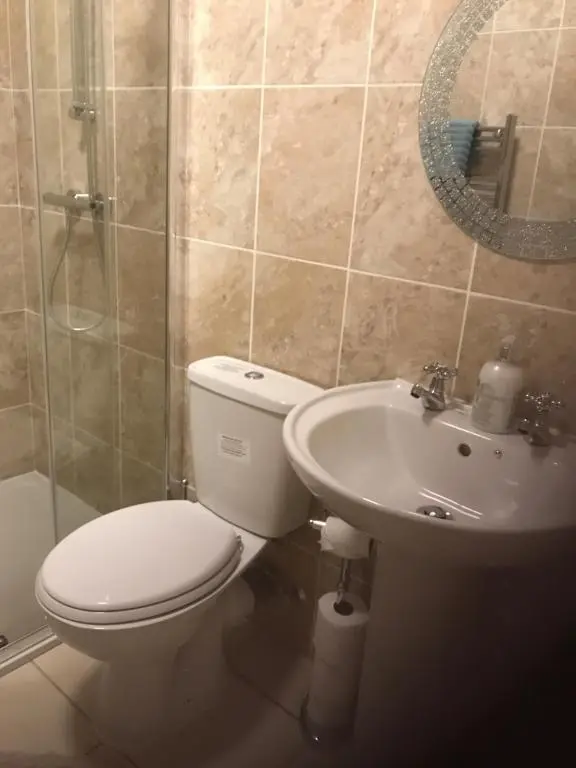 a bathroom with a toilet and a sink and a shower at River Ness Apartments in Inverness