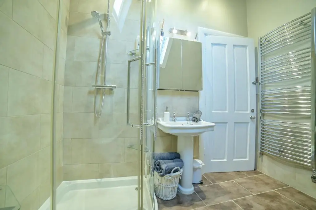 a bathroom with a shower and a sink at Kylelachin in Dingwall