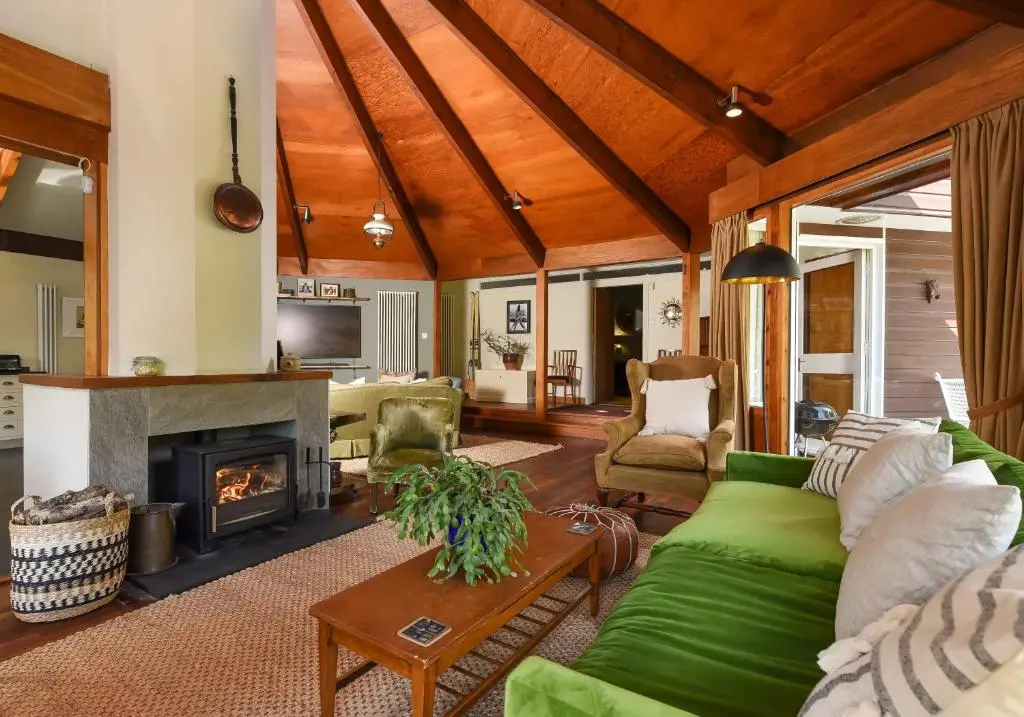 a living room with a couch and a fireplace at Cairngorm Lodge Rothiemurchus in Aviemore