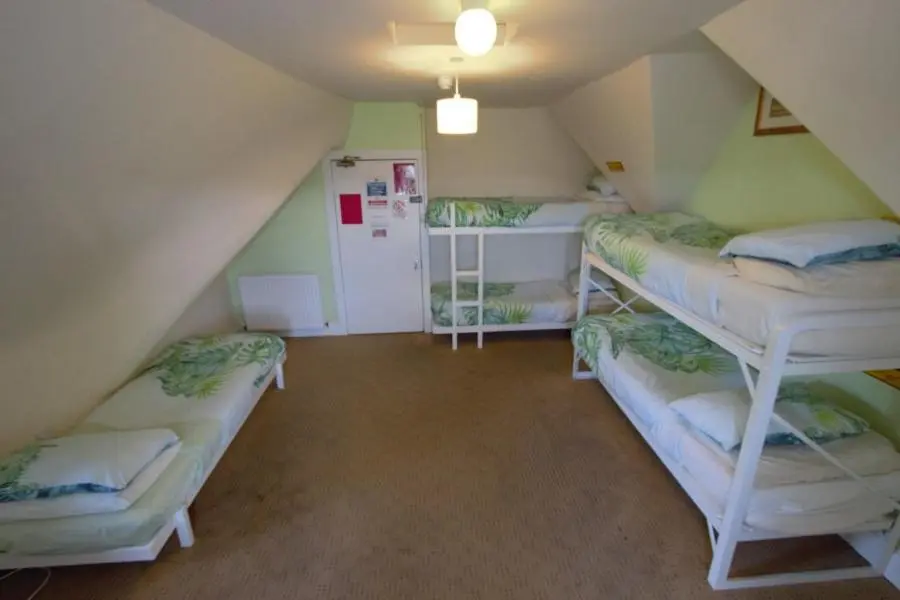 a attic room with four bunk beds in it at Inverness Student Hotel in Inverness