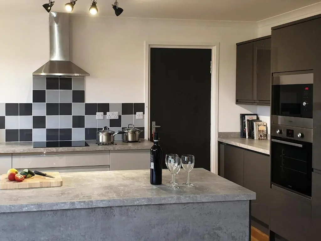 a kitchen with two glasses of wine on a counter at Auldfield in Lhanbryd