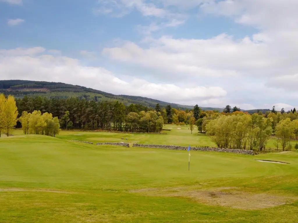 a view of a golf course with mountains in the background at 22 Queens Court in Inchmarlo