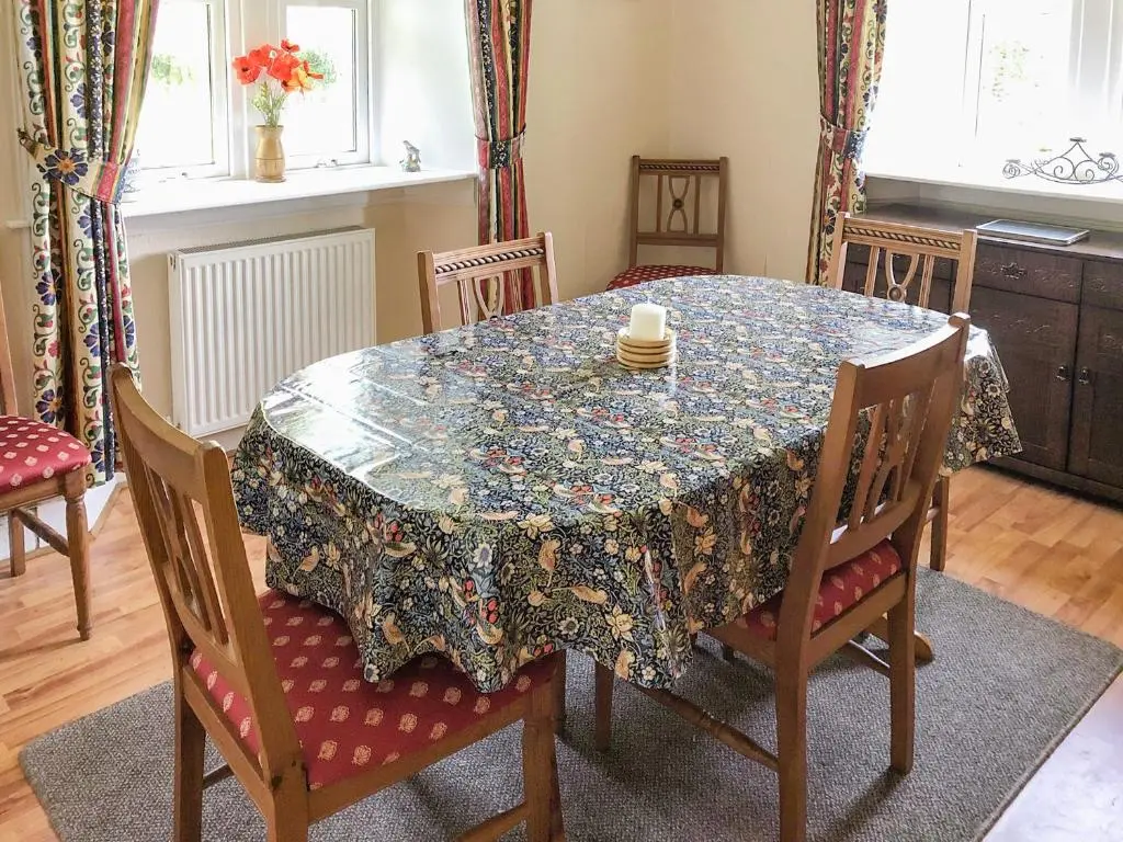 a dining room table with a table cloth on it at The Gate Lodge in Latheron
