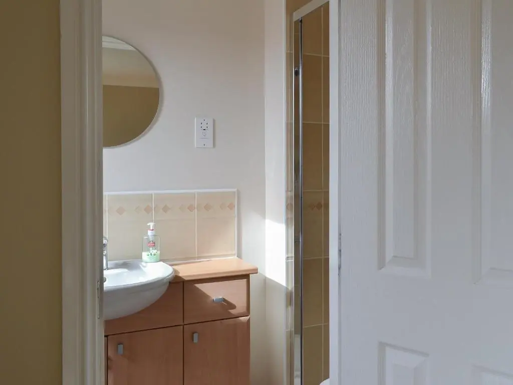 a bathroom with a sink and a mirror at Stags Neuk in Aviemore