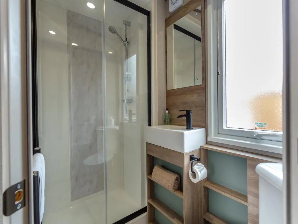 a bathroom with a sink and a glass shower at The Pines in Aviemore