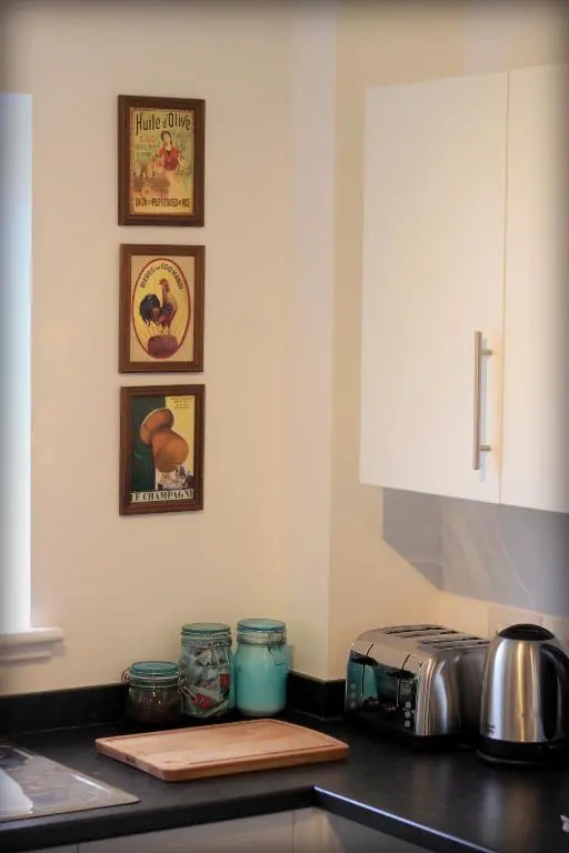 a kitchen with a counter top with a toaster oven and pictures at Ventoux in Aviemore