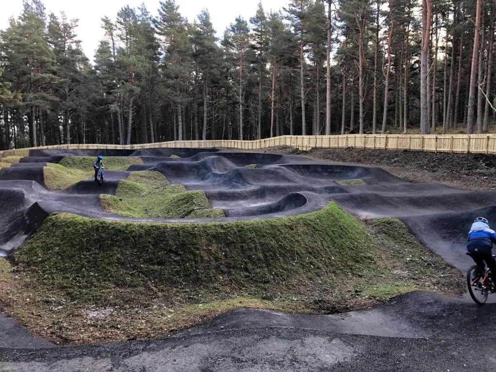two people riding bikes in a skate park at Ventoux in Aviemore