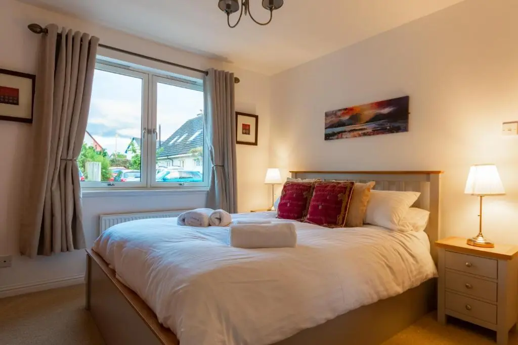 a child laying on a bed in a bedroom at Tigh na Lochan in Aviemore