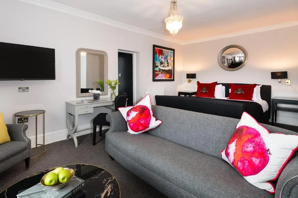 a living room with a couch and a bed at The Old Manse of Blair, Boutique Hotel & Michelin Restaurant in Blair Atholl