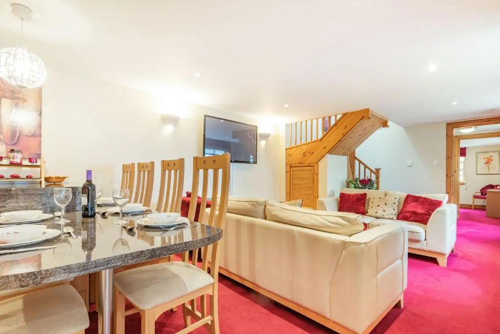 a living room with a couch and a table at Dunstaffnage Cottage in Grantown on Spey
