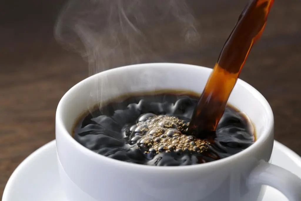 a cup of coffee with a spoon in it at Blervie House in Forres