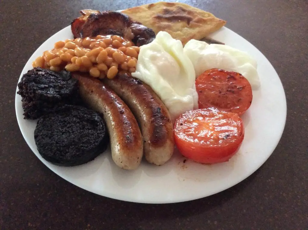 a plate of breakfast food with sausage beans and bread at Rudan Guest House AB53 6UQ in New Deer