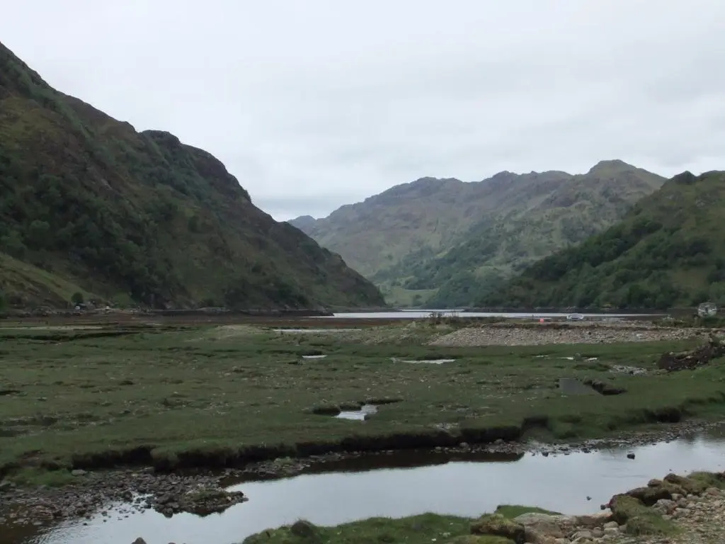 a river in a valley with mountains in the background at Foyers Roost in Foyers