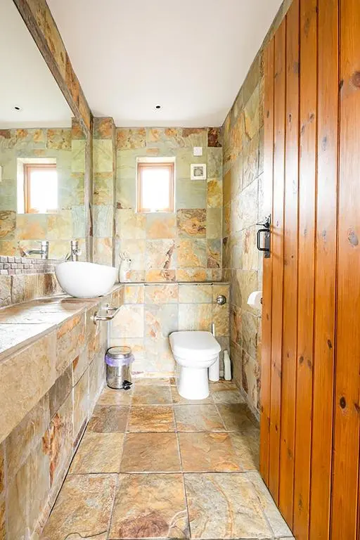 a bathroom with a toilet and a sink at Coach House at Soilzarie in Blairgowrie