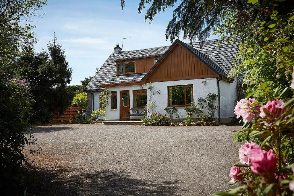a house with a driveway in front of it at Rowans Inverness in Inverness