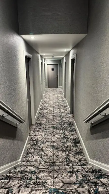 a long hallway with a tile floor in a building at The Knowes Hotel & Restaurant in Macduff