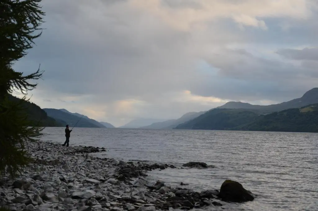 a person standing on the shore of a body of water at Averon House in Inverness