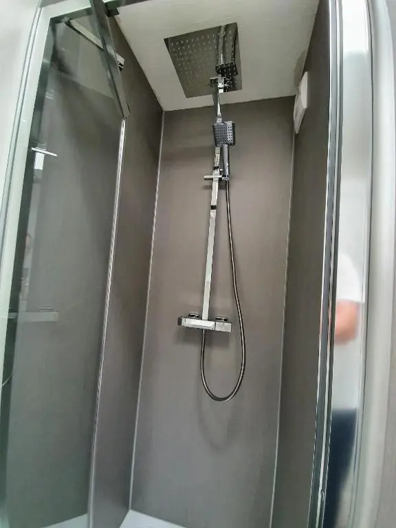 a shower with a shower head and a shower at Doric House in Inverness