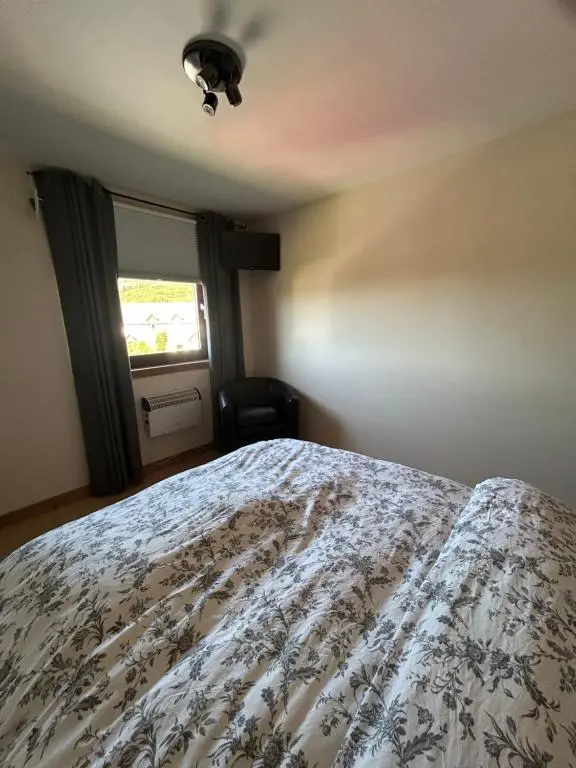 a bedroom with a bed and a window at No 52 - Apartment with Lounge and Dining Area - No kitchen in Ullapool