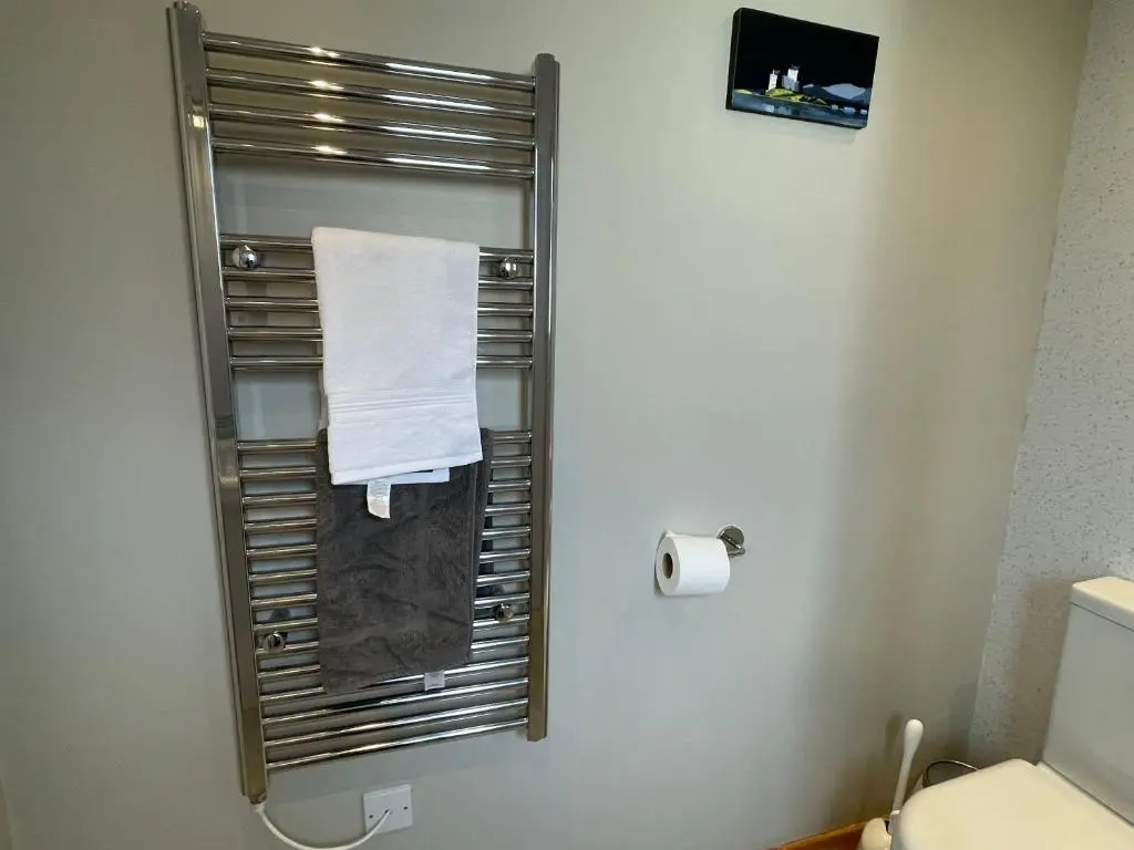 a bathroom with a towel rack and a toilet at Hillside View, Inverness in Inverness