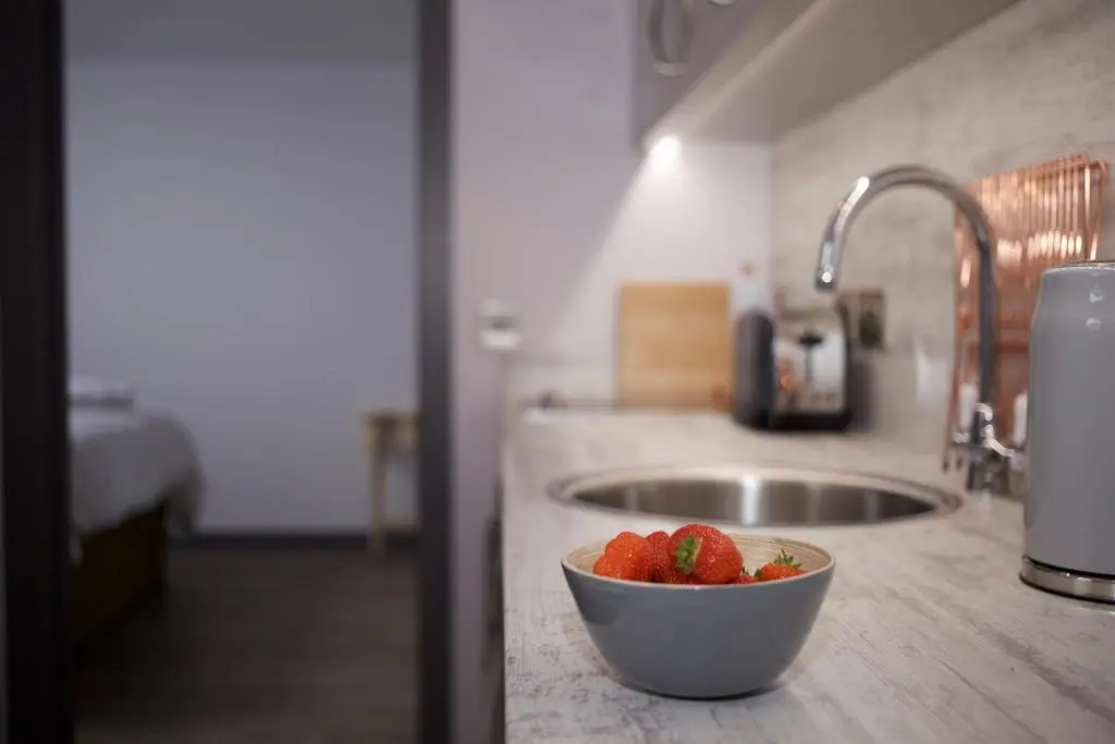 a bowl of strawberries sitting on a counter in a kitchen at The Lodges @ Barra Castle in Inverurie
