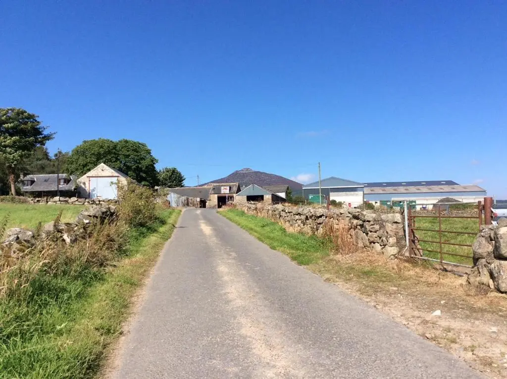 a road leading to a farm with a stone wall at Broadsea in Inverurie