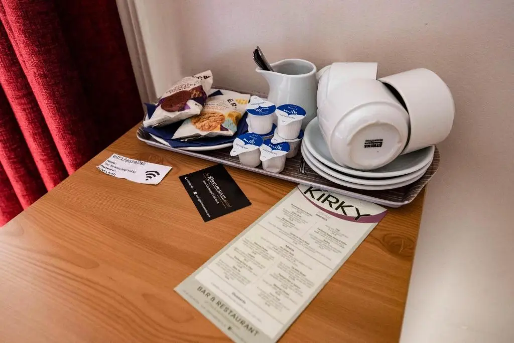 a table with a tray of food and cups and plates at The Kirkmichael Hotel in Kirkmichael