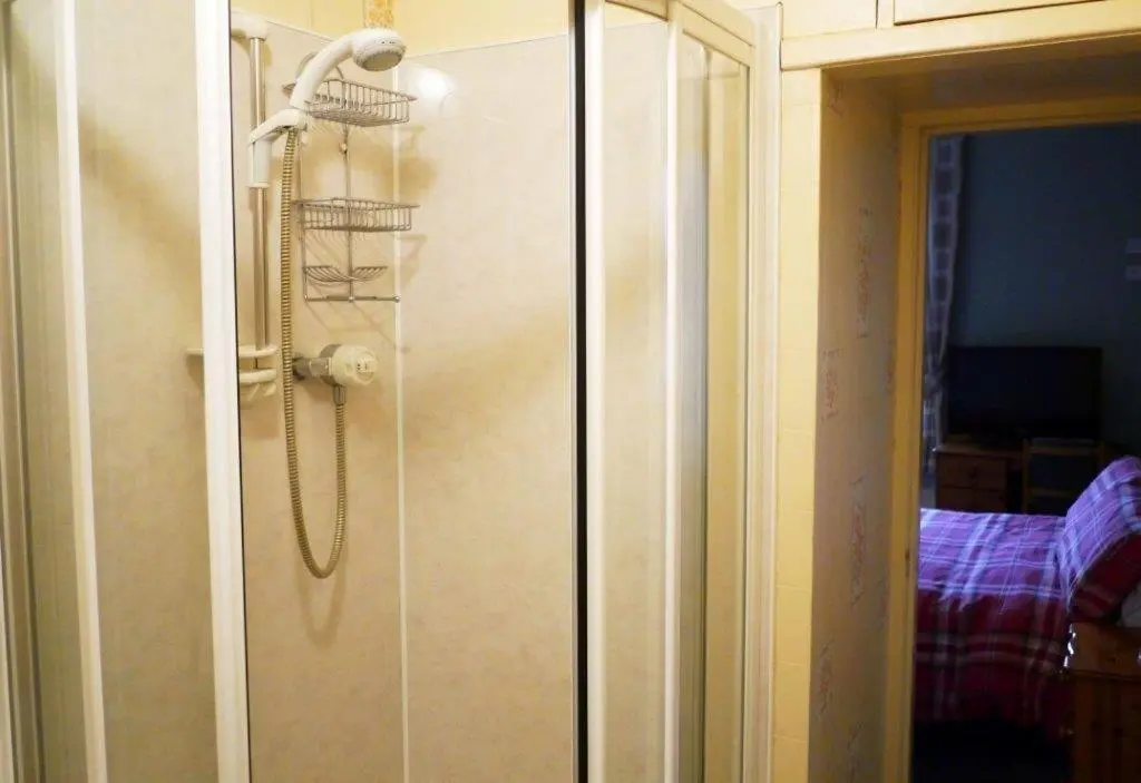 a shower with a shower head in a bathroom at Elgin Guest House in Elgin
