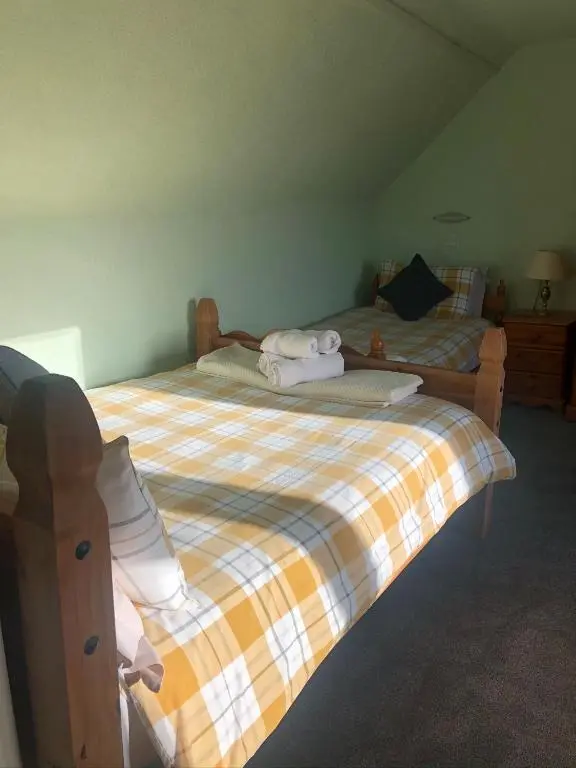 a bedroom with two beds with towels on them at Elgin Guest House in Elgin