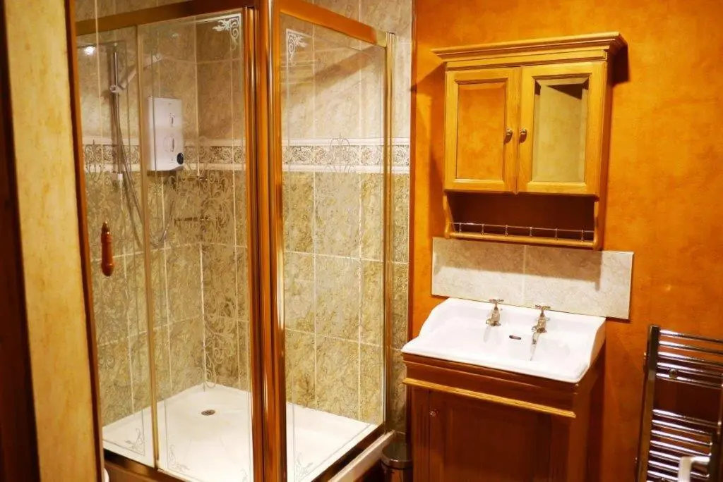 a bathroom with a shower and a sink at Elgin Guest House in Elgin