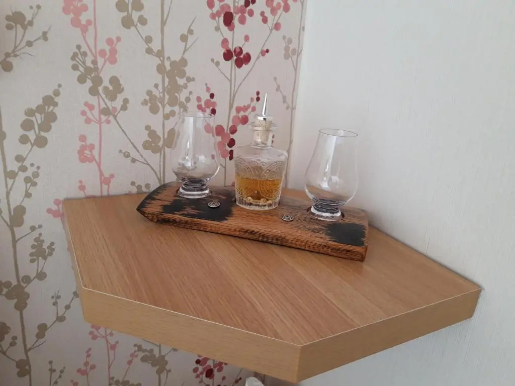 a wooden shelf with two glasses on top of it at Gowanbrae in Dufftown
