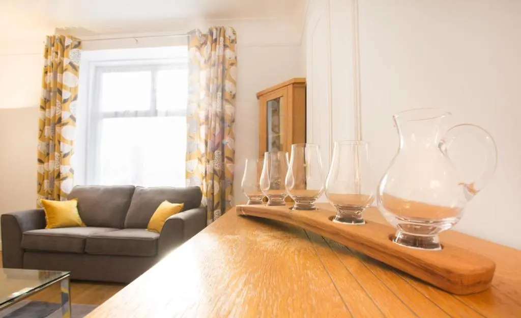 a group of glass vases on a table in a living room at Crown Apartment in Inverness