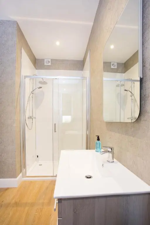 a bathroom with a sink and a shower at Crown Apartment in Inverness
