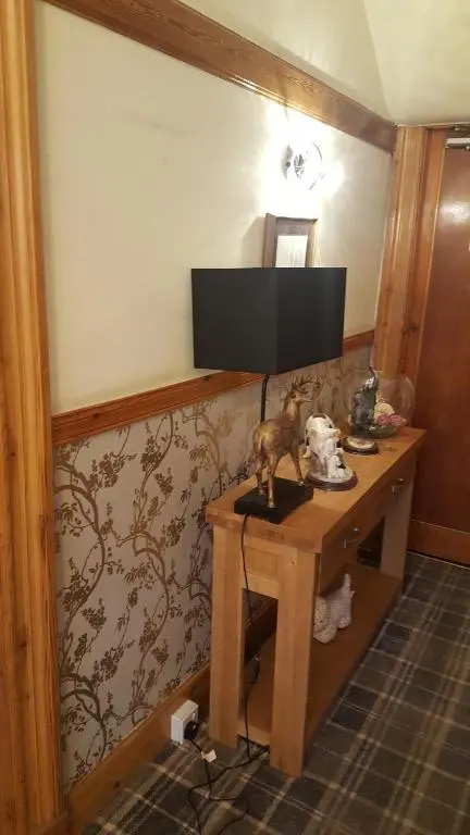 a desk with a television on top of it at Ivanhoe Guest House in Inverness