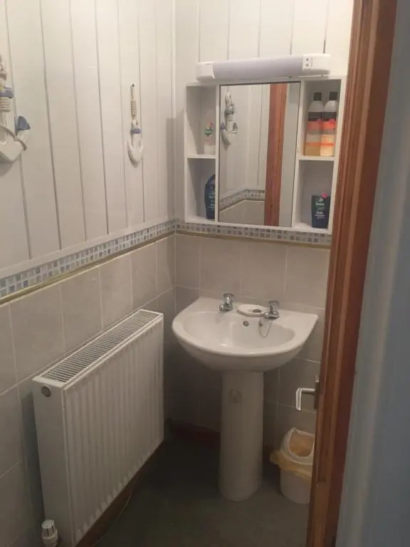 a bathroom with a sink and a mirror at Ivanhoe Guest House in Inverness