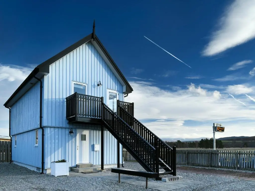 a house with a staircase on the side of it at Signal Box in Newtonmore