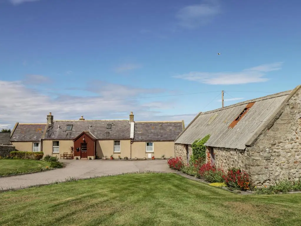 a group of houses with a driveway and a barn at Braehead Croft in Portessie