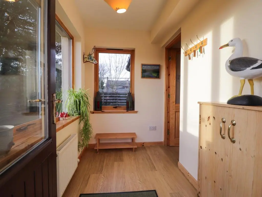 a hallway with a duck statue on top of a cabinet at Bruach Gorm Cottage in Grantown on Spey