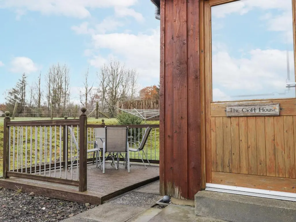 a wooden door with a sign that reads the get hurt at The Croft House in Muir of Ord