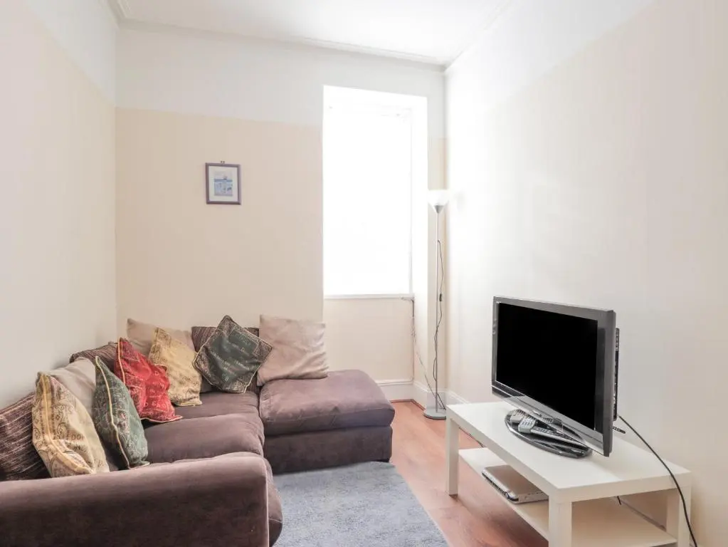a living room with a couch and a tv at 1 Seafield Street in Cullen