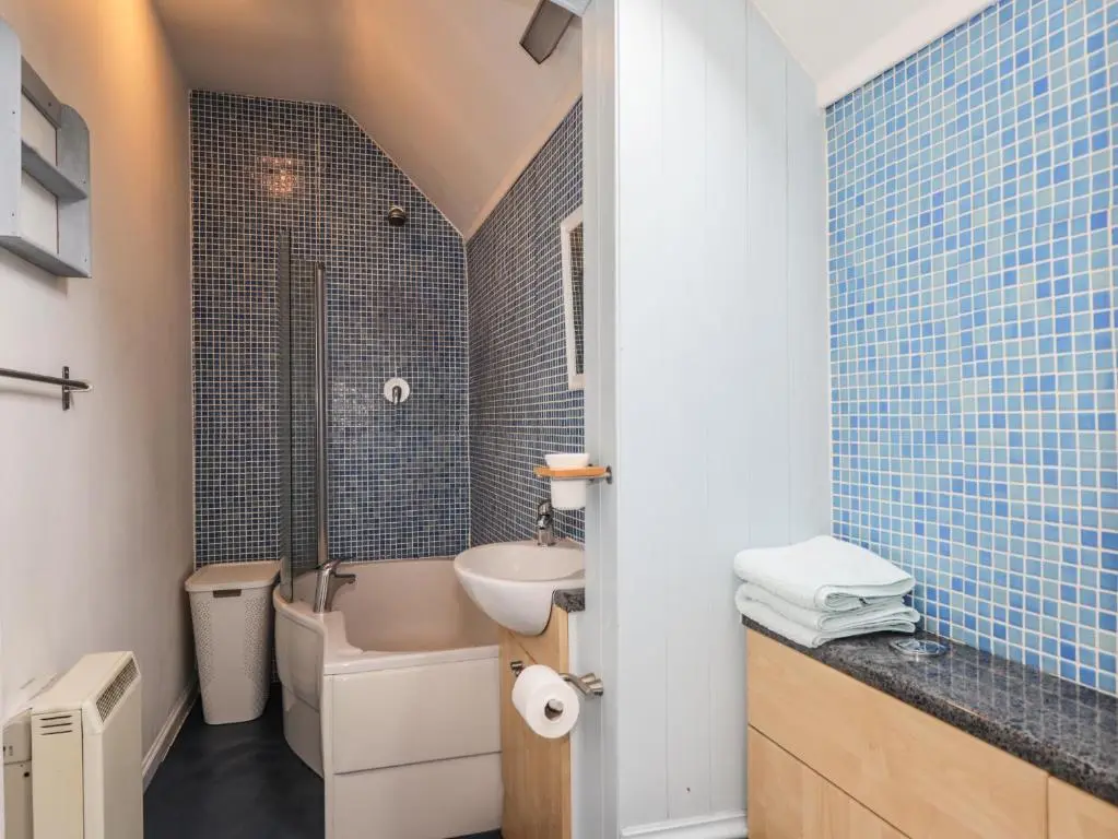 a bathroom with a sink and a toilet and a shower at Aultmore in Kingussie