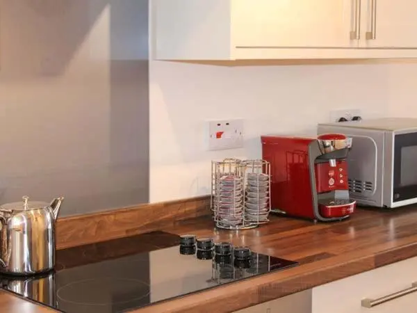 a kitchen with a counter top with a microwave and a counter sidx sidx at Slater's in Portknockie