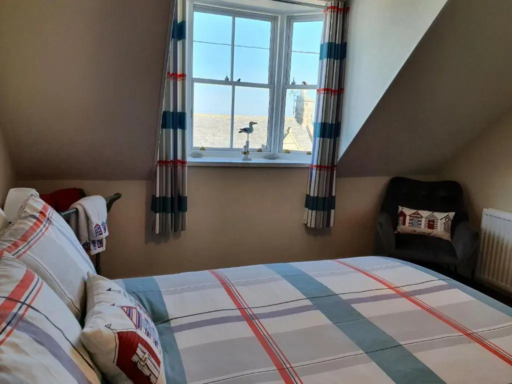 a bedroom with a bed and a window at Slater's in Portknockie