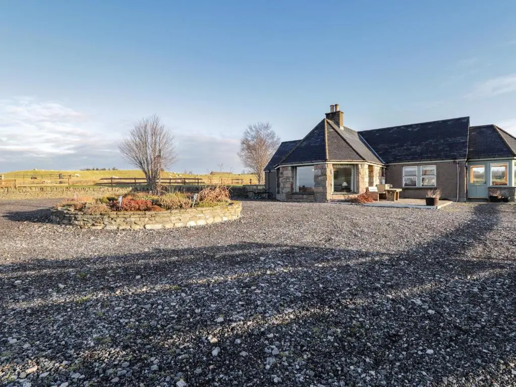 a house with a gravel driveway in front of it at Bogairn in Carron