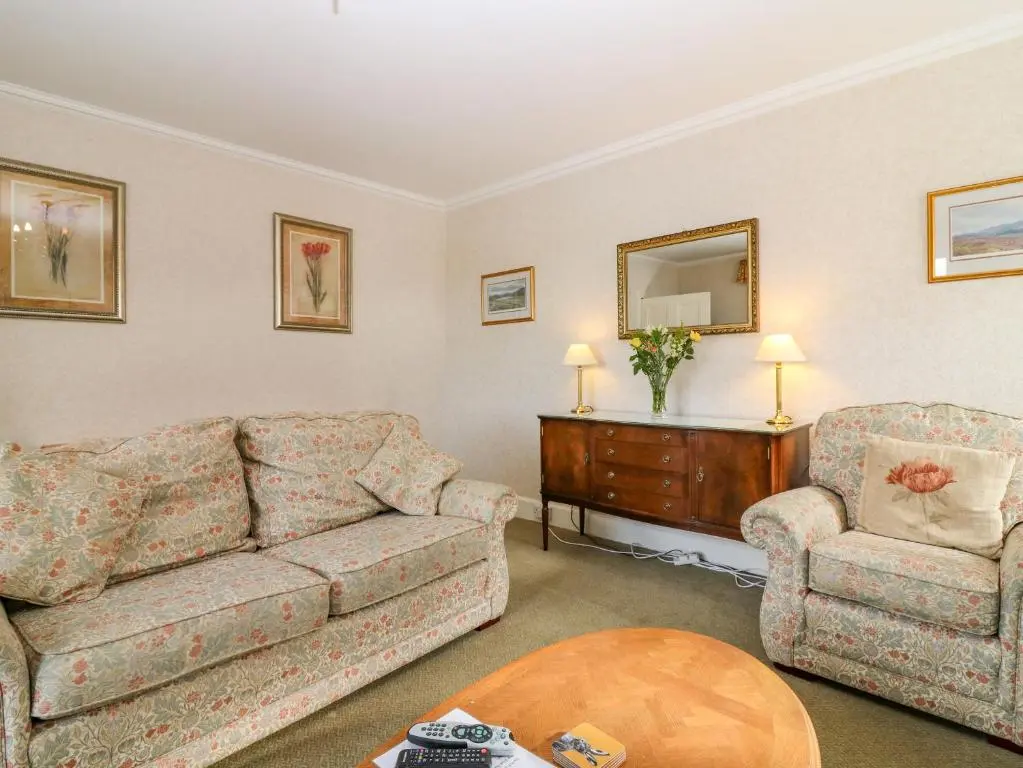 a living room with a couch and a chair at The West Wing in Skye of Curr