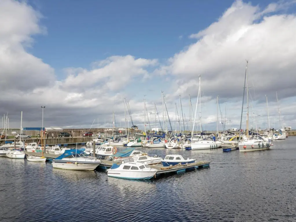 a bunch of boats docked in a harbor at Deskford Cottage in Balblair