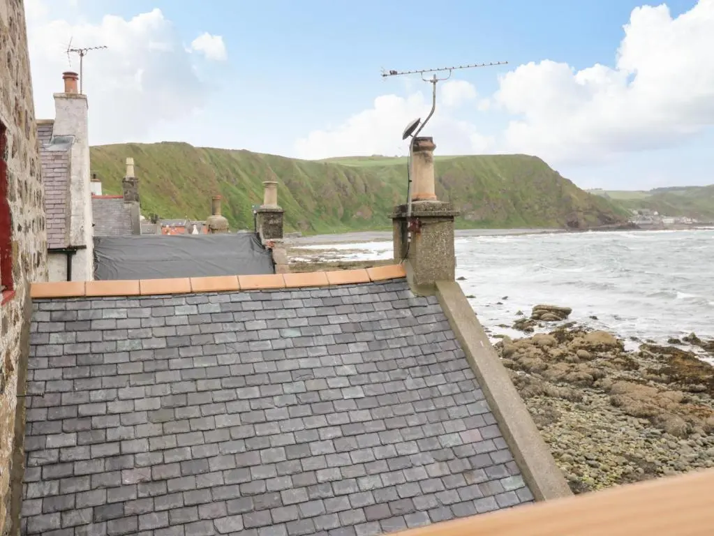 a set of stairs leading down to the beach at 49 Crovie Village in Gardenstown