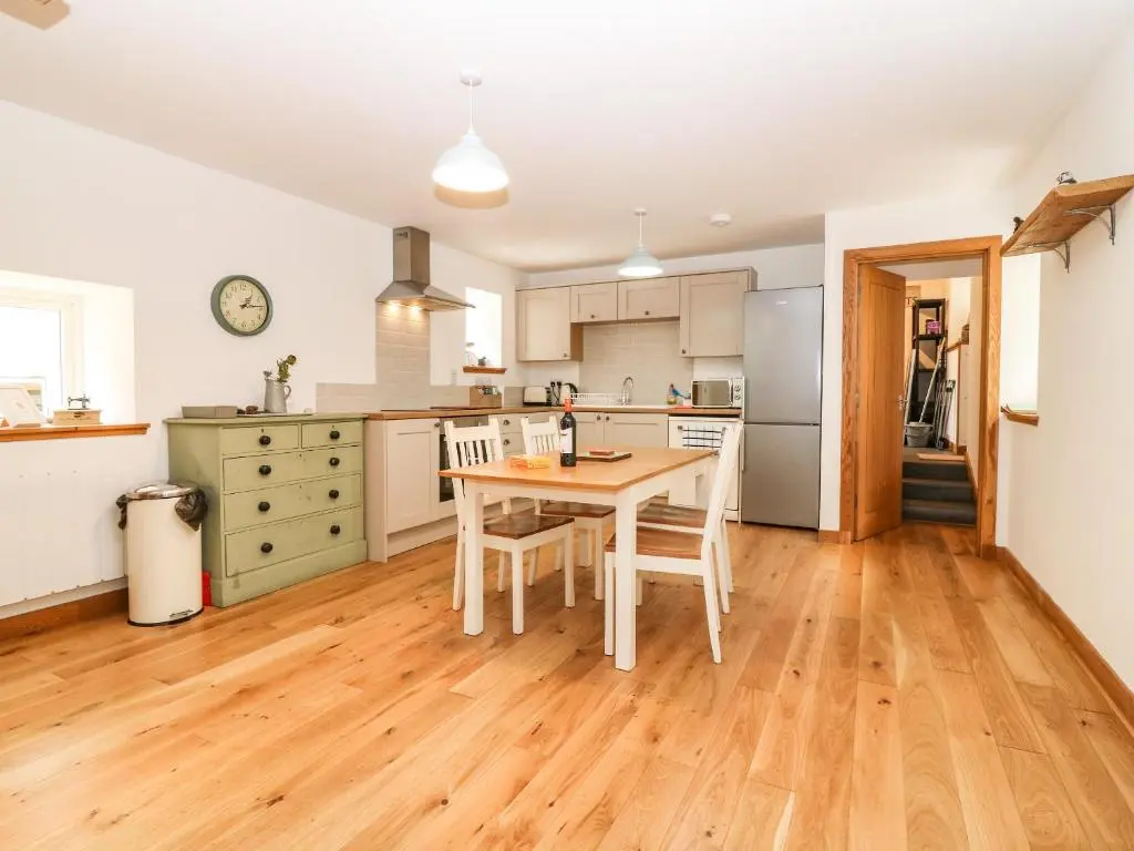 a kitchen with a table and chairs in it at 49 Crovie Village in Gardenstown
