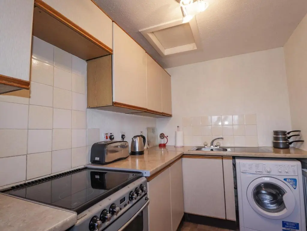 a kitchen with a sink and a dishwasher at Alt na Voir in Tomintoul