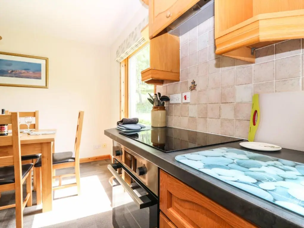 a kitchen with a stove and a counter top at Birchbank in Skye of Curr